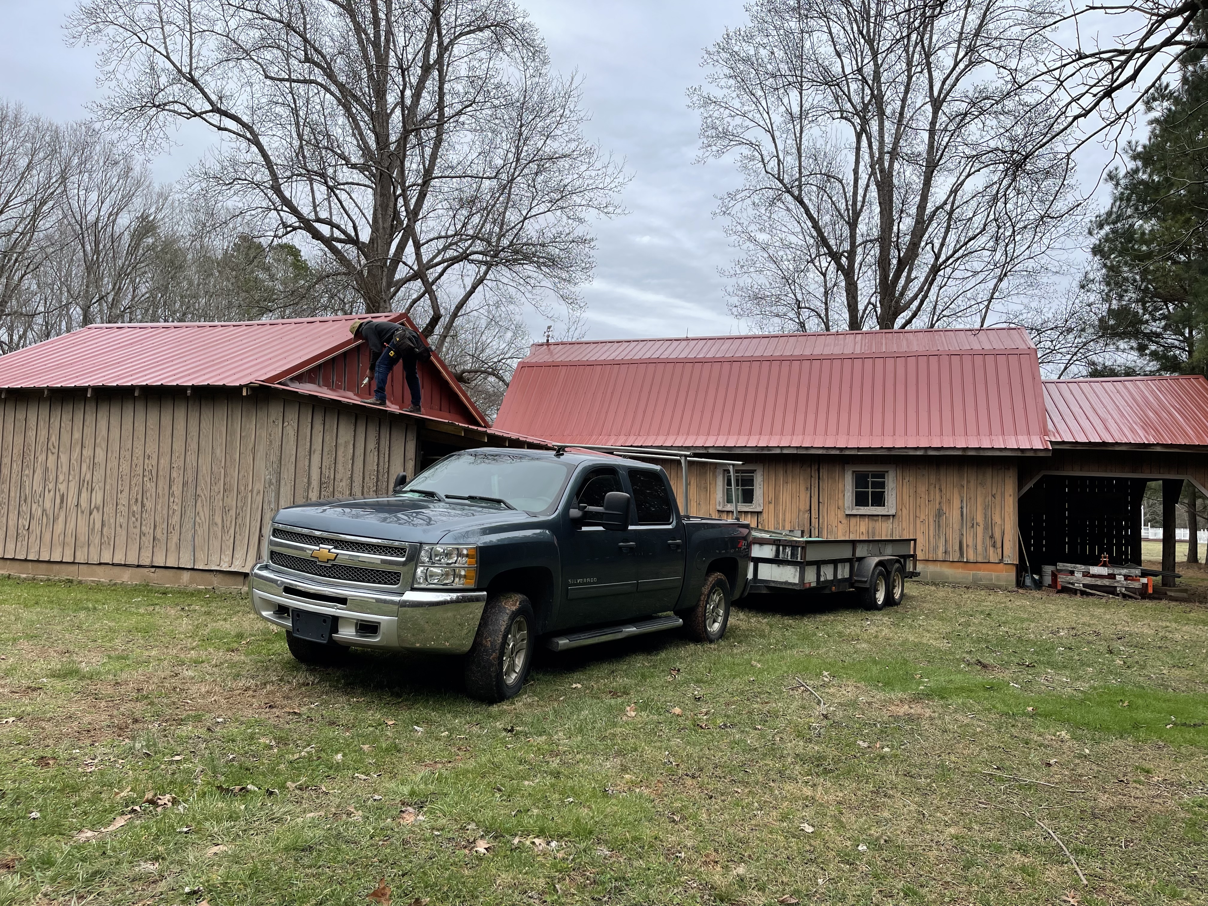 Red metal roof barn install
