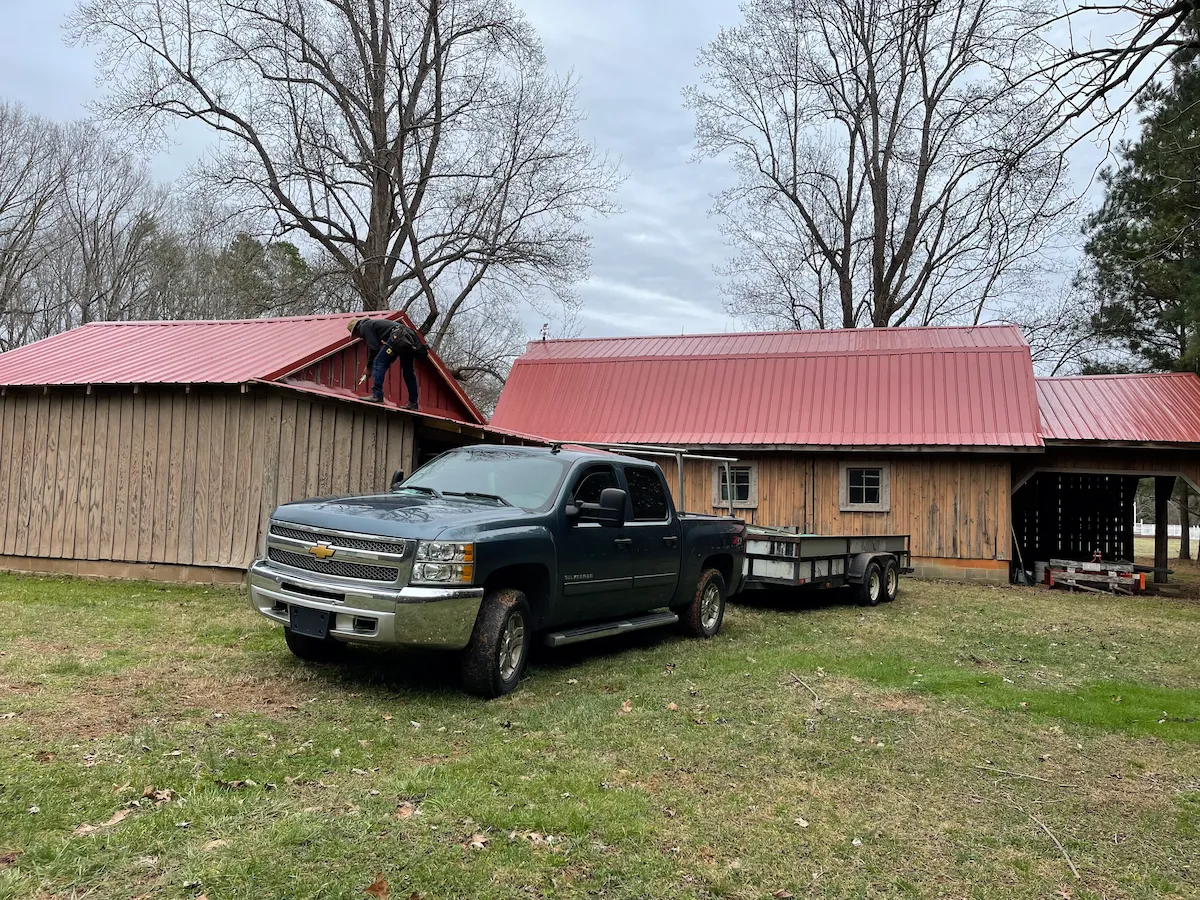 Red metal roof barn install