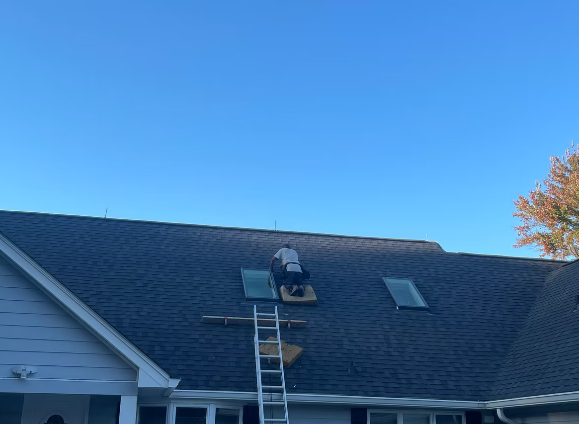 Skylight repair on dark shingle roof